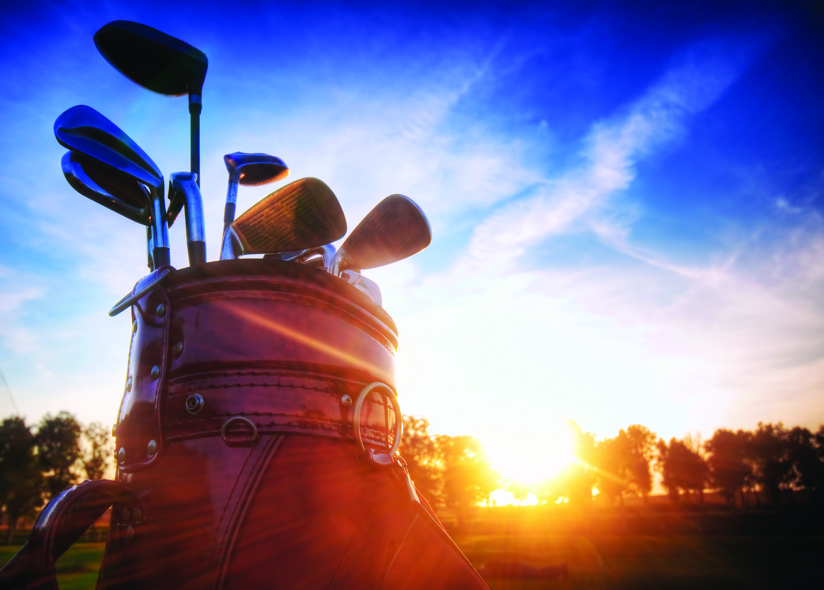Professional golf gear on the golf field at sunset.
